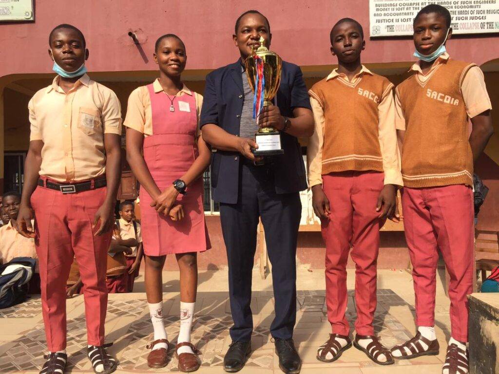 The manager receiving the Awka Diocesan Quiz Trophy