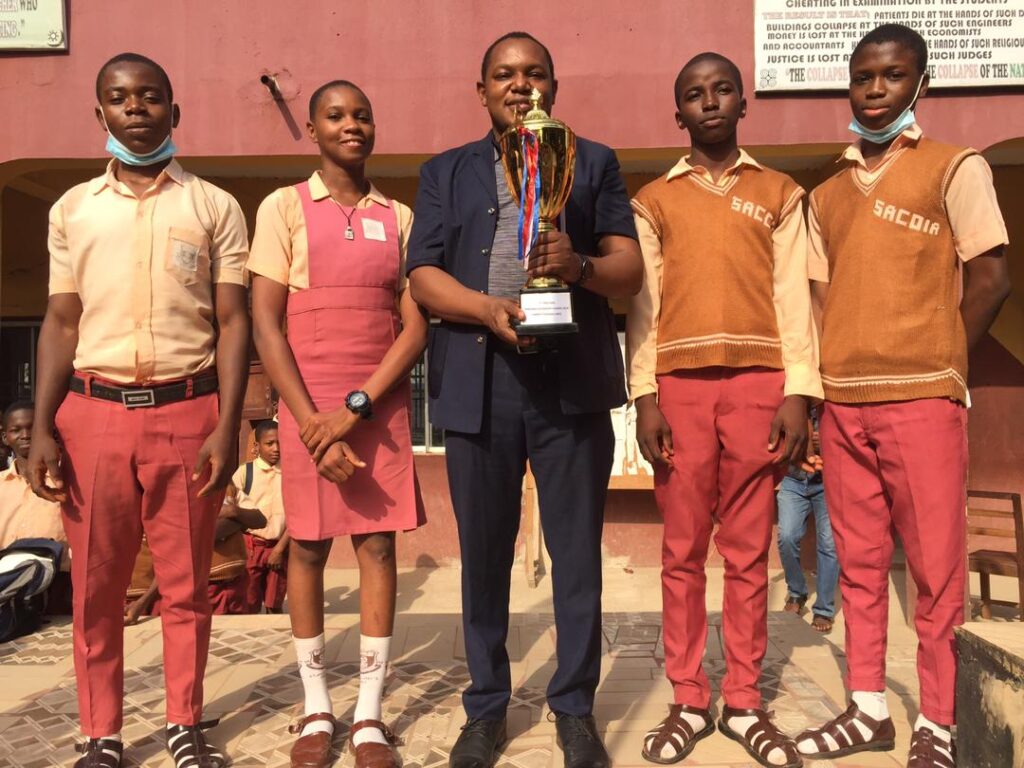 The manager receiving the Awka Diocesan Quiz Trophy